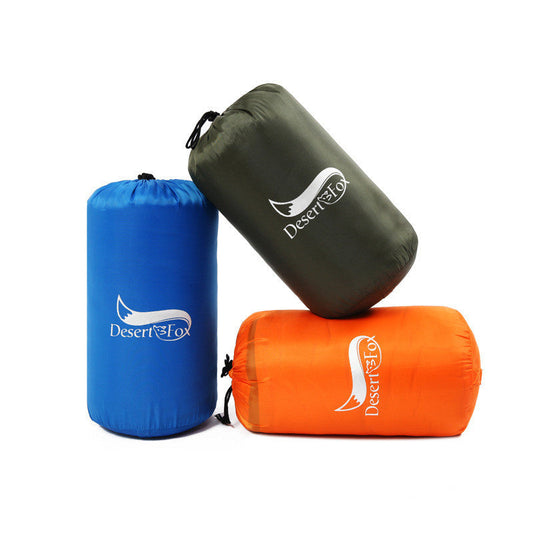 An AlphaLife247 3-season sleeping bag shown partially unzipped on a camping site, highlighting its durable polyester construction and hollow cotton insulation for outdoor thermal comfort.