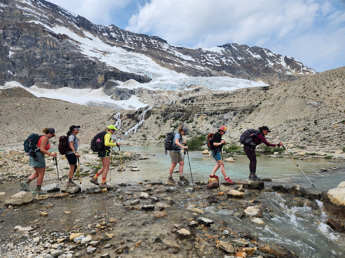 AlphaLife247 News Outdoor Camping Hiking featuring Hikers crossing a mountain stream