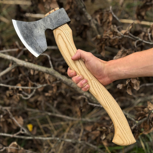 AlphaLife247 hand-forged carbon steel carving axe with ergonomic ash wood handle, designed for precision bushcraft and woodworking.