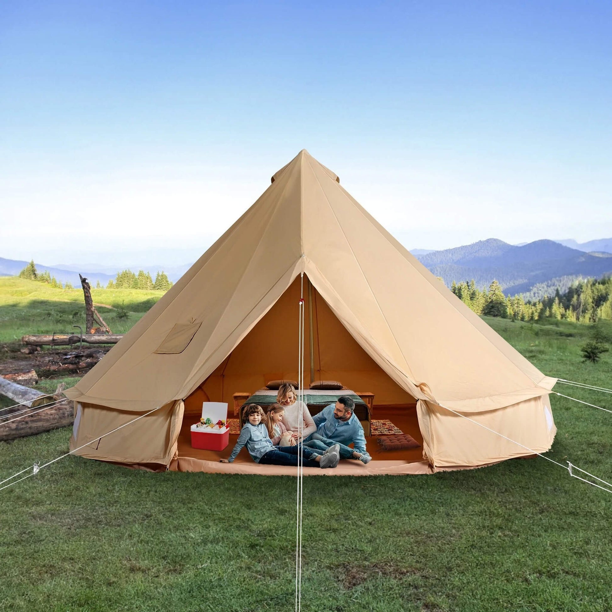 Premium 4-season canvas bell yurt tent set up in a lush, grassy field with mountain views, showcasing its spacious interior and rugged design for family and expedition camping.