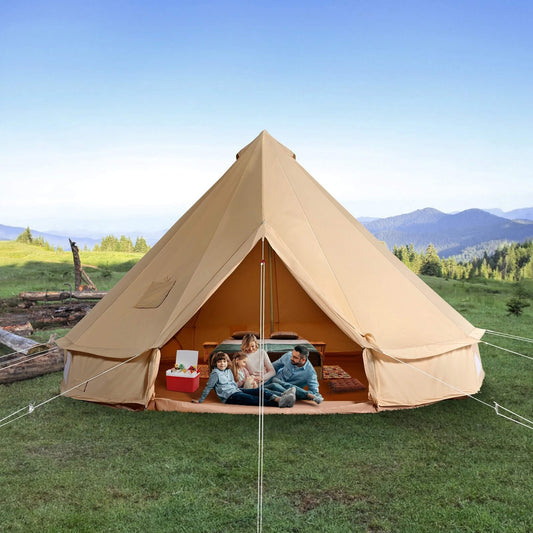 Premium 4-season canvas bell yurt tent set up in a lush, grassy field with mountain views, showcasing its spacious interior and rugged design for family and expedition camping.